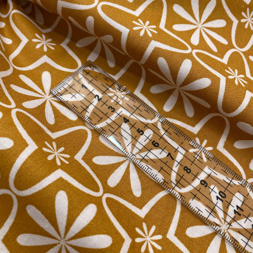 Tissu coton imprimé fleurs géométriques vintage sur fond moutard